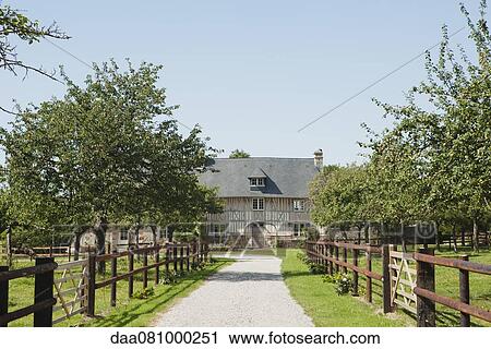 Stock Image - Path leading to half-timbered farmhouse. Fotosearch
