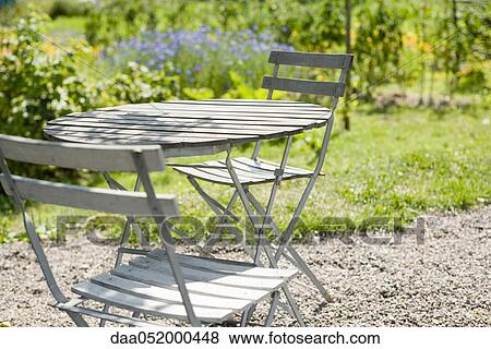 Stock Photo - Patio furniture in backyard. Fotosearch