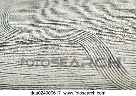 Stock Photo - Pattern traced in sand, full frame. Fotosearch
