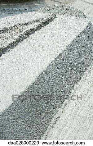Stock Photo - Patterns raked in gravel, close-up. Fotosearch