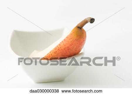 Pear slice in dish, close-up View Large Photo Image Stock Photo - Pear slice in dish, close-up. Fotosearch
