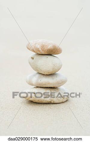 Pebbles stacked on sand, close-up View Large Photo Image Stock Photography - Pebbles stacked on sand, close-up. Fotosearch
