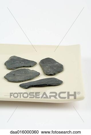 Pieces of stone on dish View Large Photo Image Stock Image - Pieces of stone on dish. Fotosearch