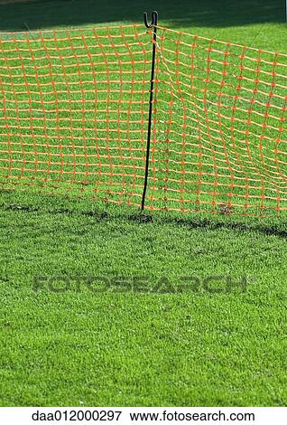 Plastic mesh fence on grass View Large Photo Image Stock Photo - Plastic mesh fence on grass. Fotosearch