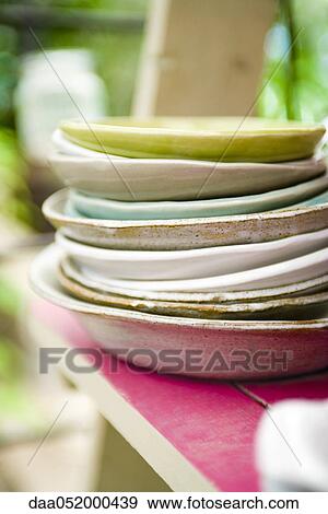 Stock Photo - Plates stacked on shelf. Fotosearch
