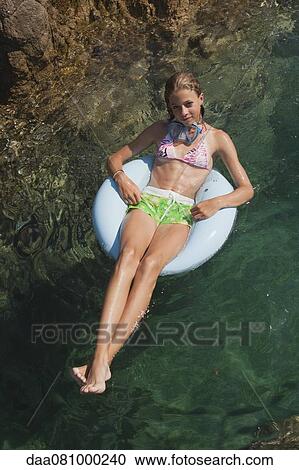 Preteen girl floating on water View Large Photo Image Stock Image - Preteen girl floating on water. Fotosearch