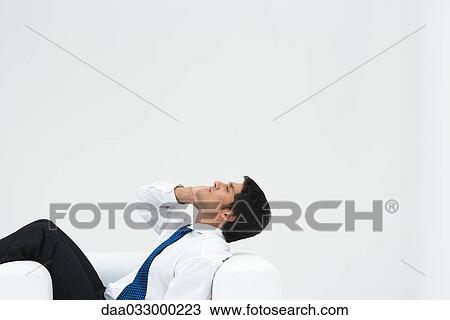 Professional man reclining in armchair, head back, on the phone View Large Photo Image Stock Image - Professional man reclining in armchair, head back, on the phone. Fotosearch