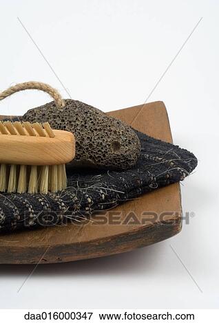 Pumice stone, nail brush, and exfoliation glove on wooden tray, partial view View Large Photo Image Stock Photo - Pumice stone, nail brush, and exfoliation glove on wooden tray, partial view. Fotosearch