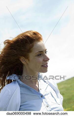 Redheaded woman in nature, portrait View Large Photo Image Stock Photo - Redheaded woman in nature, portrait. Fotosearch