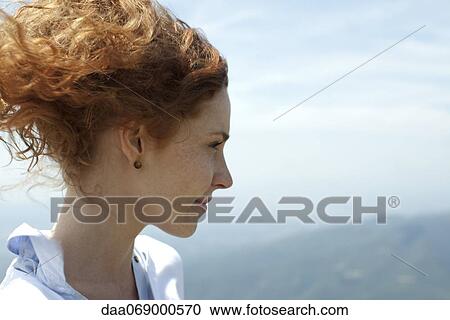 Redheaded woman looking at view, profile View Large Photo Image Stock Image - Redheaded woman looking at view, profile. Fotosearch