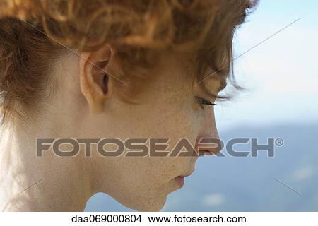 Redheaded woman with hair up, side view View Large Photo Image Picture - Redheaded woman with hair up, side view. Fotosearch