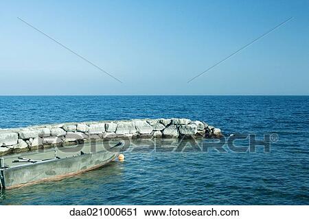 Rowboat and breakwater in lake View Large Photo Image Stock Image - Rowboat and breakwater in lake. Fotosearch