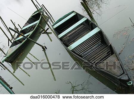 Rowboats floating in water, tilt View Large Photo Image Stock Photo - Rowboats floating in water, tilt. Fotosearch