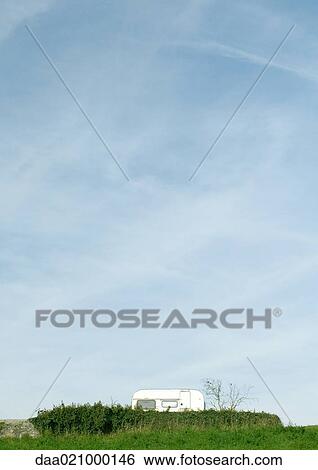 RV parked in rural landscape, behind hedges View Large Photo Image Stock Photograph - RV parked in rural landscape, behind hedges. Fotosearch