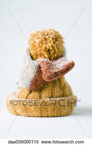 Scarf wrapped around knit hat, snow-covered View Large Photo Image Stock Photography - Scarf wrapped around knit hat, snow-covered. Fotosearch