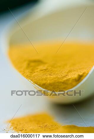 Scoop full of turmeric, extreme close-up View Large Photo Image Stock Photo - Scoop full of turmeric, extreme close-up. Fotosearch