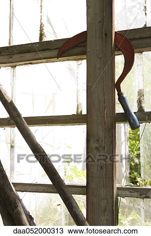 Scythe hanging on greenhouse wall View Large Photo Image Stock Image - Scythe hanging on greenhouse wall. Fotosearch