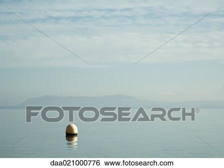 Stock Photograph - Seascape, buoy in foreground. Fotosearch