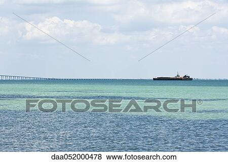 Seascape with barge on horizon View Large Photo Image Stock Photo - Seascape with barge on horizon. Fotosearch