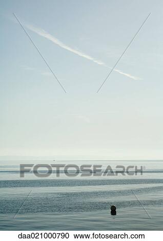 Seascape with buoy in foreground View Large Photo Image Stock Image - Seascape with buoy in foreground. Fotosearch