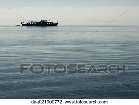Seascape with silhouette of boat View Large Photo Image Stock Image - Seascape with silhouette of boat. Fotosearch
