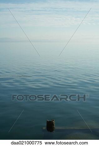 Seascape, wooden posts underwater in foreground View Large Photo Image Stock Photography - Seascape, wooden posts underwater in foreground. Fotosearch