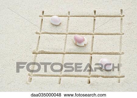 Seashells arranged on grid drawn in sand, close-up View Large Photo Image Stock Photo - Seashells arranged on grid drawn in sand, close-up. Fotosearch