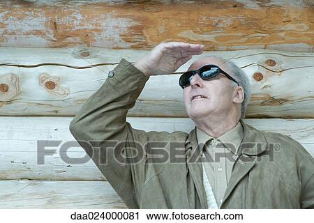 Senior man shading eyes View Large Photo Image Stock Image - Senior man shading eyes. Fotosearch