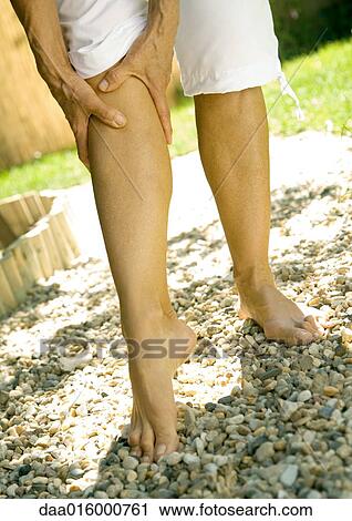 Senior woman holding leg, low section View Large Photo Image Stock Image - Senior woman holding leg, low section. Fotosearch