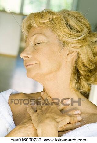 Senior woman smiling with eyes closed, hands at throat View Large Photo Image Stock Photo - Senior woman smiling with eyes closed, hands at throat. Fotosearch