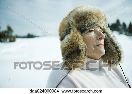 Senior woman standing in snowy landscape, head and shoulders View Large Photo Image Picture - Senior woman standing in snowy landscape, head and shoulders. Fotosearch