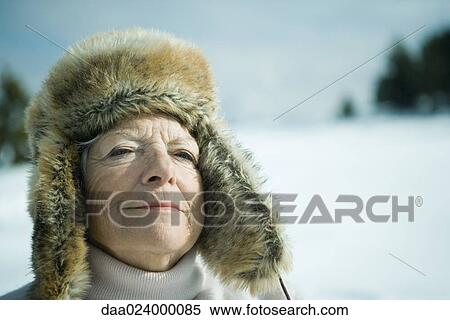 Senior woman standing in snowy landscape, eyes closed, smiling, head and shoulders View Large Photo Image Stock Photography - Senior woman standing in snowy landscape, eyes closed, smiling, head and shoulders. Fotosearch