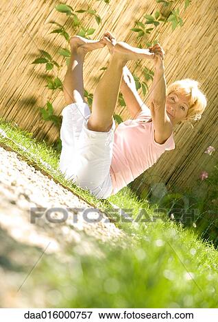 Senior woman stretching outdoors View Large Photo Image Stock Photo - Senior woman stretching outdoors. Fotosearch