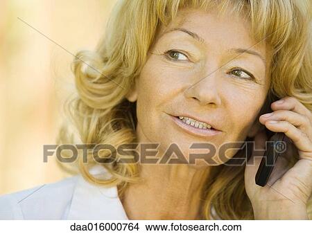 Picture - Senior woman using cell phone. Fotosearch