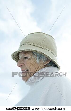 Senior woman wearing warm clothes, head and shoulders View Large Photo Image Stock Photograph - Senior woman wearing warm clothes, head and shoulders. Fotosearch