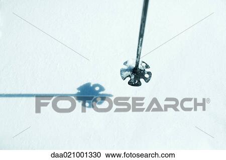 Stock Image - Ski stick over snow, close-up. Fotosearch