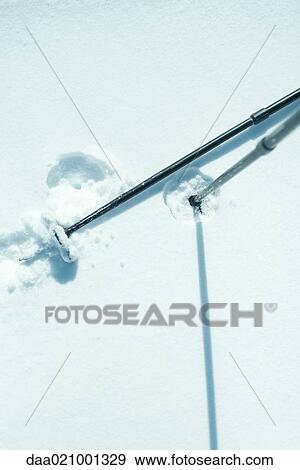 Stock Photo - Ski sticks in snow, close-up. Fotosearch