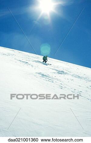 Skier skiing downhill View Large Photo Image Stock Image - Skier skiing downhill. Fotosearch
