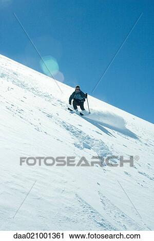Skier skiing downhill View Large Photo Image Stock Image - Skier skiing downhill. Fotosearch