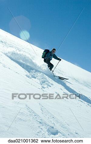 Skier skiing downhill View Large Photo Image Stock Image - Skier skiing downhill. Fotosearch