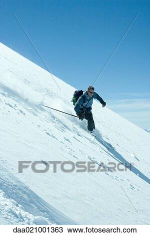 Skier skiing downhill View Large Photo Image Stock Image - Skier skiing downhill. Fotosearch