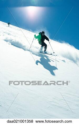 Stock Photo - Skier skiing downhill. Fotosearch