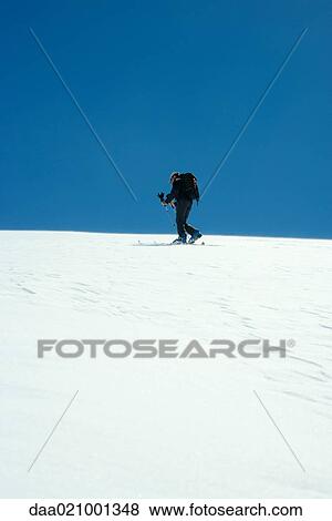 Skier standing on slope, low angle view View Large Photo Image Stock Photo - Skier standing on slope, low angle view. Fotosearch