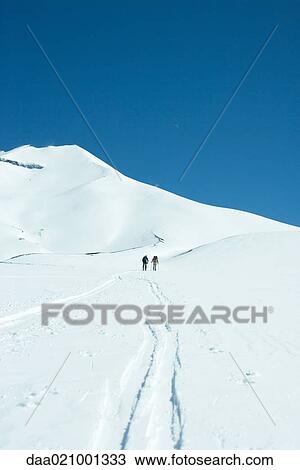 Skiers heading toward mountain, rear view View Large Photo Image Stock Image - Skiers heading toward mountain, rear view. Fotosearch
