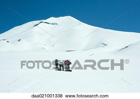 Skiers stopping, mountain in background View Large Photo Image Stock Photo - Skiers stopping, mountain in background. Fotosearch