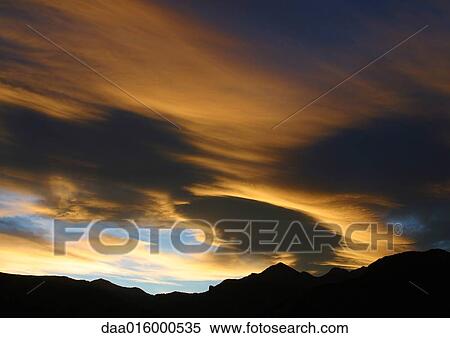 Stock Photography - Sky at sunset and silhouette of mountains. Fotosearch