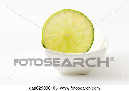 Slice of lime in small dish View Large Photo Image Stock Photography - Slice of lime in small dish. Fotosearch