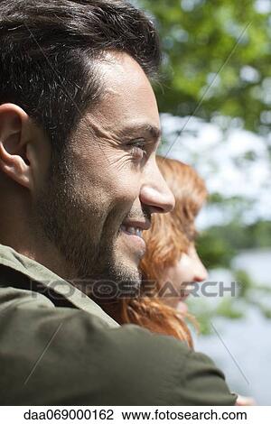 Stock Image - Smiling mid-adult man in nature. Fotosearch