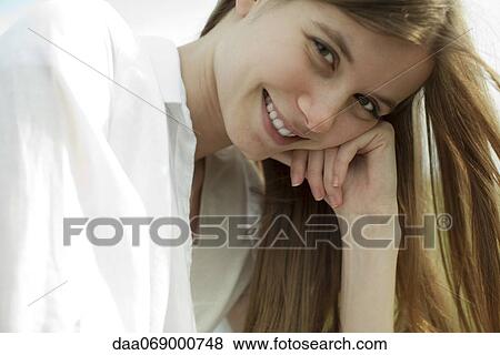 Stock Photo - Smiling young woman, portrait. Fotosearch