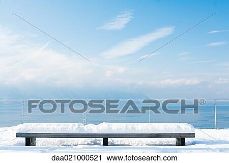 Snow-covered bench overlooking lake View Large Photo Image Stock Image - Snow-covered bench overlooking lake. Fotosearch
